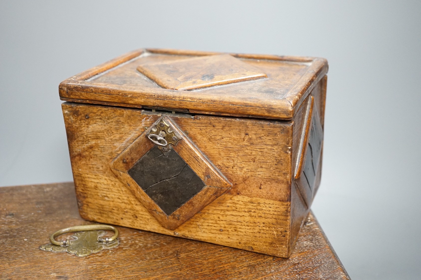 An early 18th century oak bible box containing a Victorian Morocco leather photograph album, together with two 19th century wooden boxes (4)